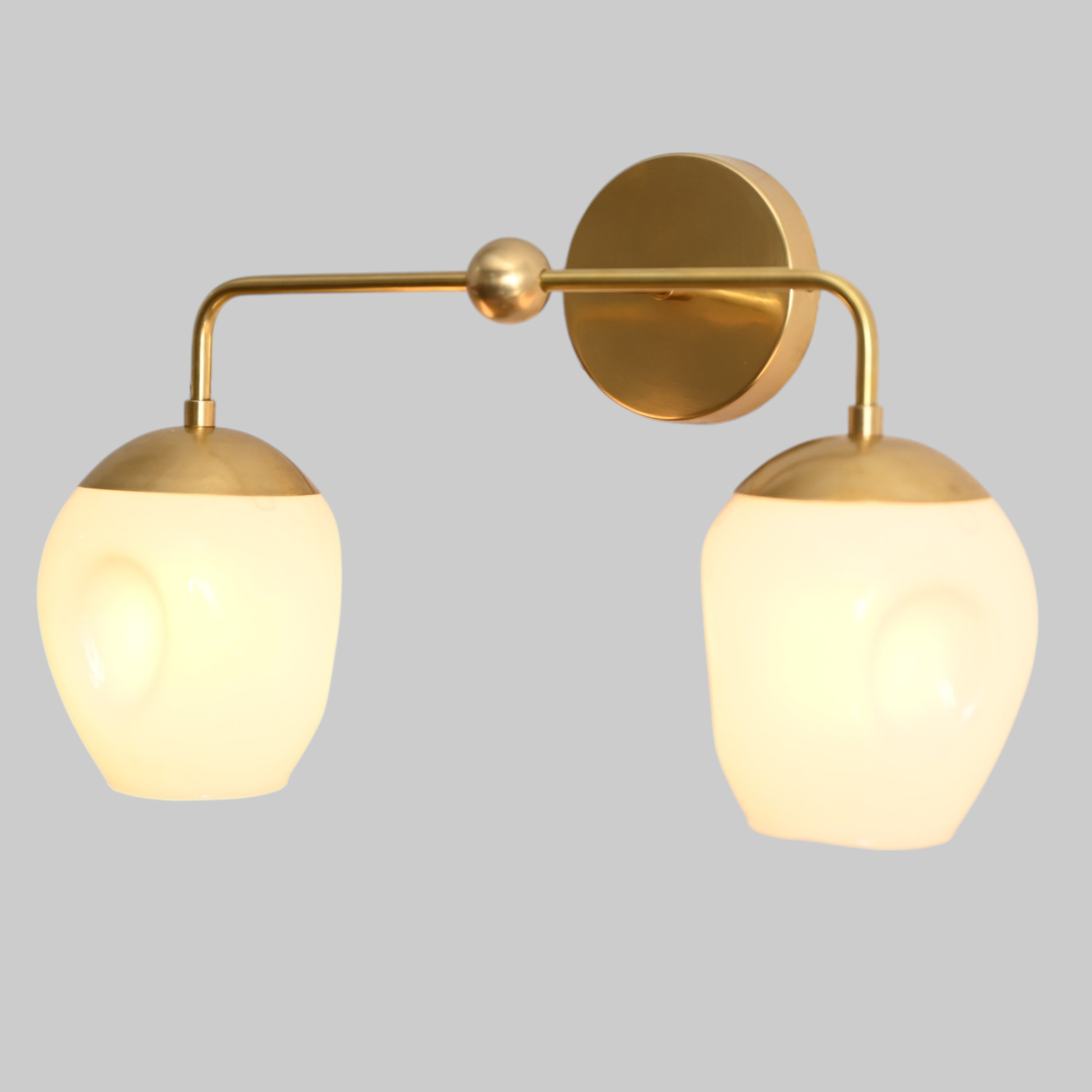 2-Light Dimple Globe Sconce: Raw brass, Mid-Century Modern, stylish ambient lighting