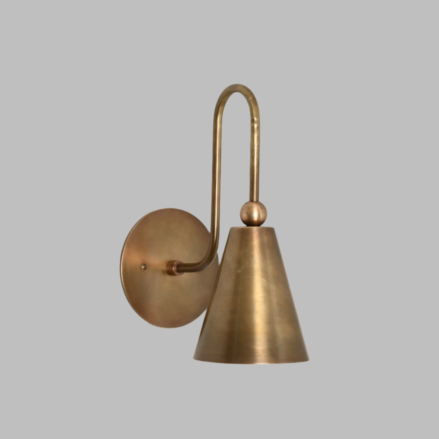 Mid-century modern wall sconces with raw brass finish and Sputnik design, adding style