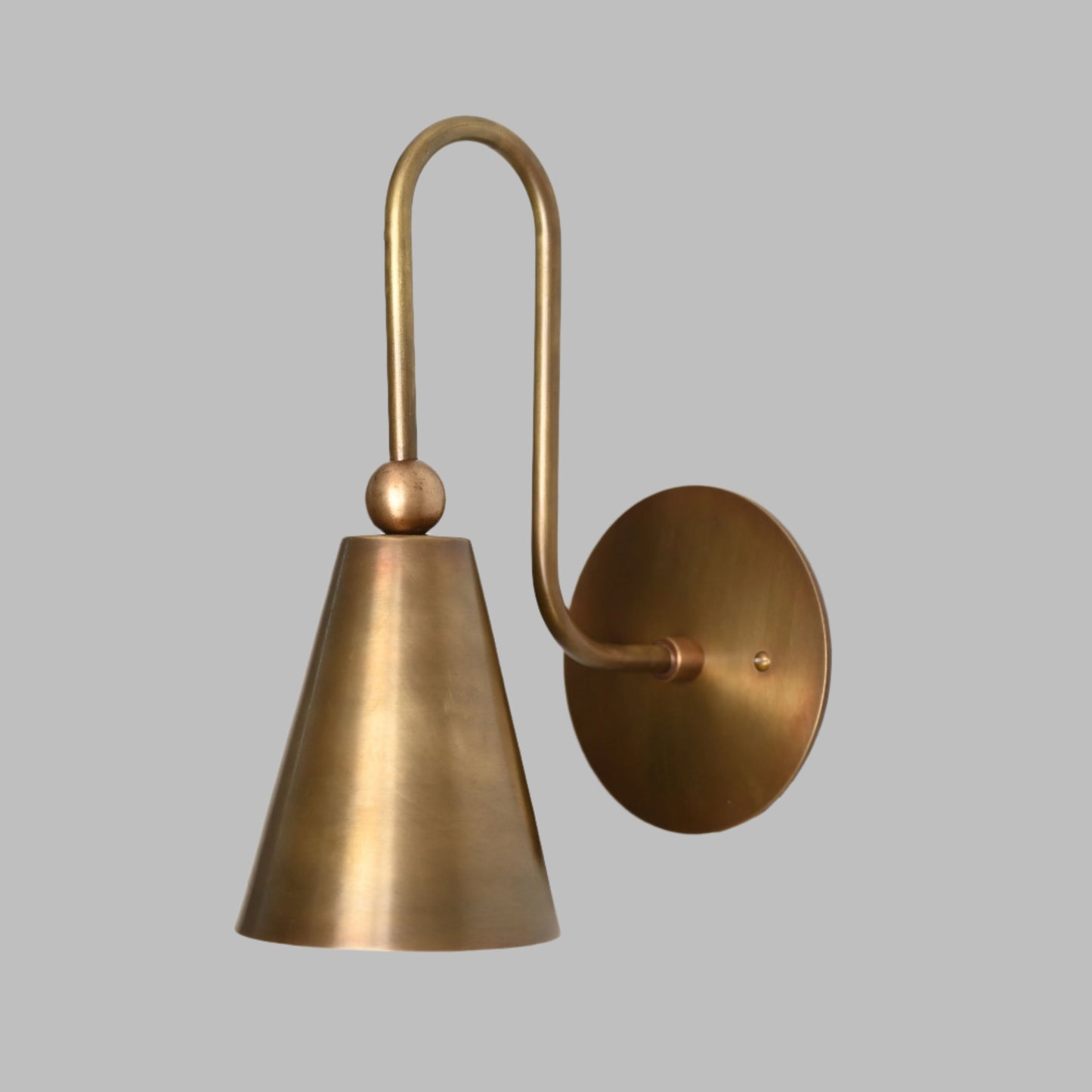 Mid-century modern wall sconces with raw brass finish and Sputnik design, adding style