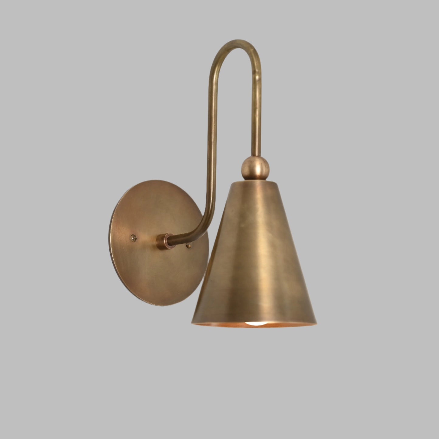 Mid-century modern wall sconces with raw brass finish and Sputnik design, adding style