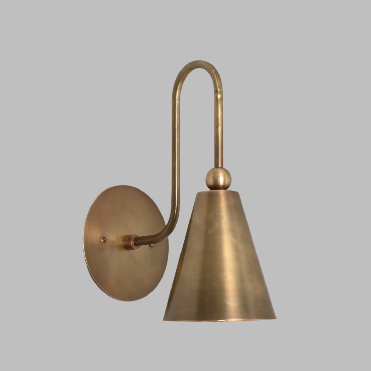 Mid-century modern wall sconces with raw brass finish and Sputnik design, adding style