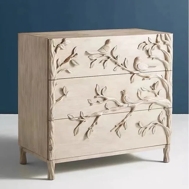 Handcrafted dresser woodland-inspired dresser featuring intricate bird and branch carvings