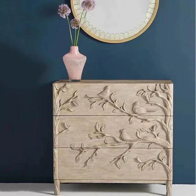 Handcrafted dresser woodland-inspired dresser featuring intricate bird and branch carvings