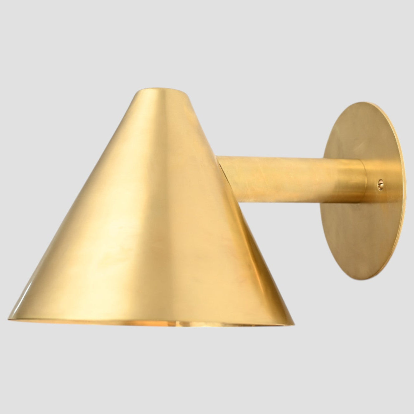 Handmade vintage wall light with a sleek cone shape for timeless, stylish design