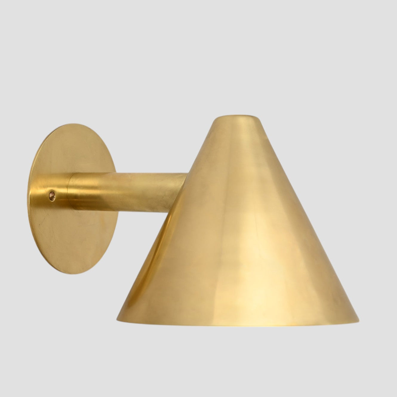 Handmade vintage wall light with a sleek cone shape for timeless, stylish design