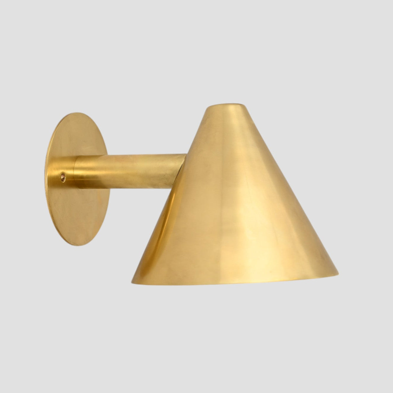 Handmade vintage wall light with a sleek cone shape for timeless, stylish design