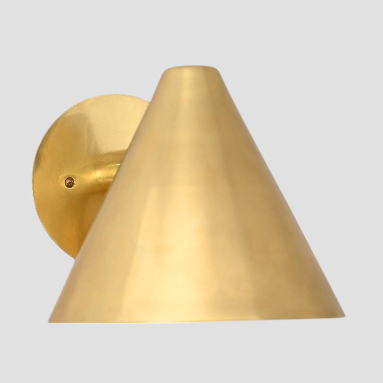 Handmade vintage wall light with a sleek cone shape for timeless, stylish design