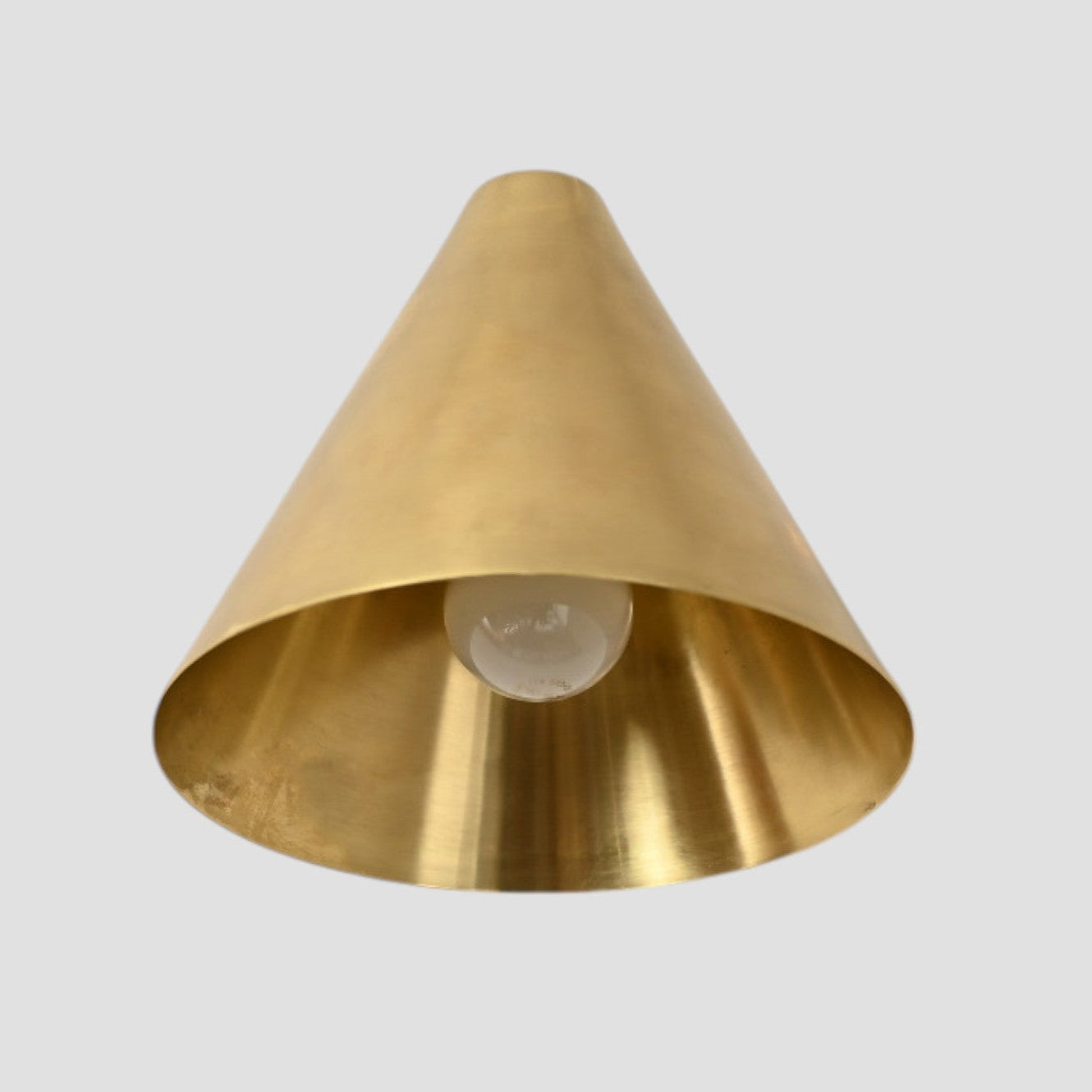 Handmade vintage wall light with a sleek cone shape for timeless, stylish design