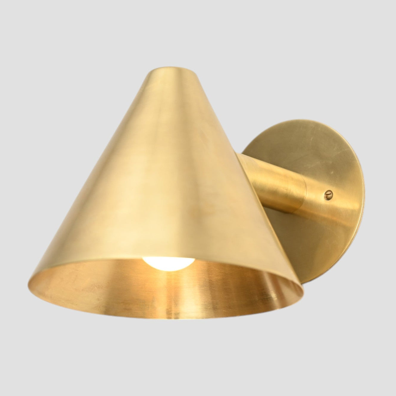 Handmade vintage wall light with a sleek cone shape for timeless, stylish design