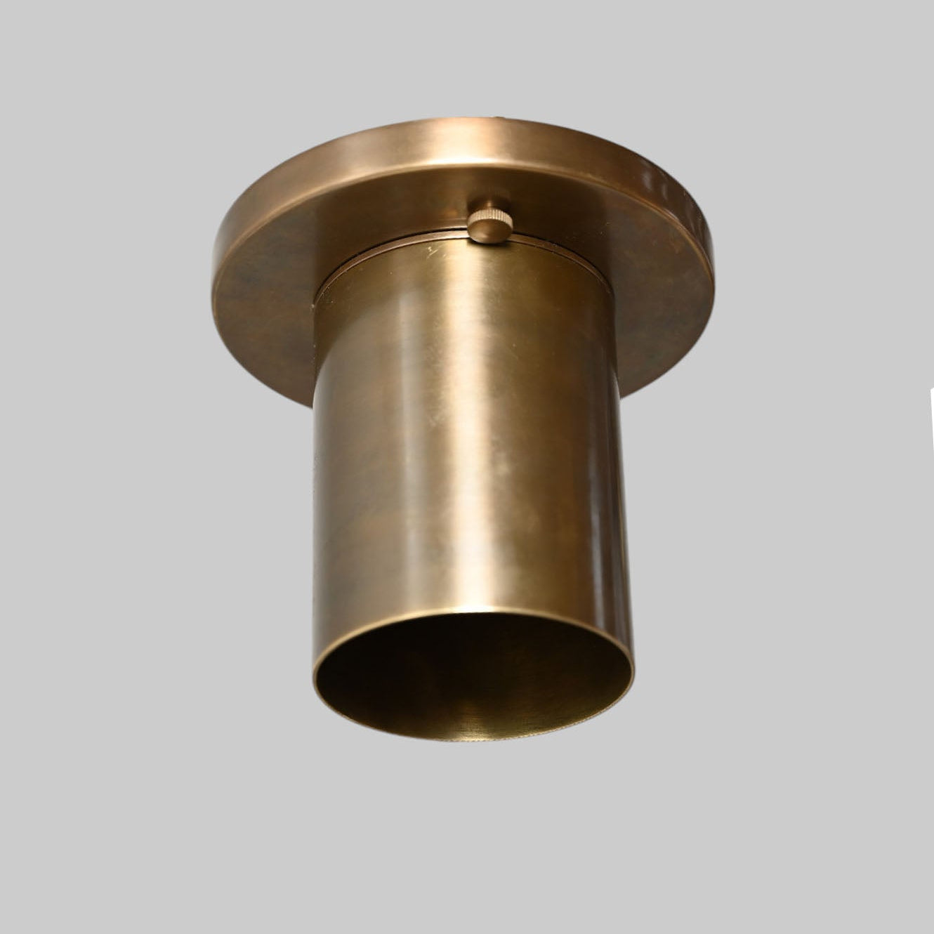 Sleek antique brass downlight adds warm, modern elegance to any space