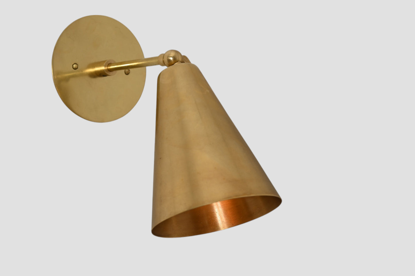Mid-Century Modern Cone Wall Light: Raw brass, radiant glow, sleek timeless design