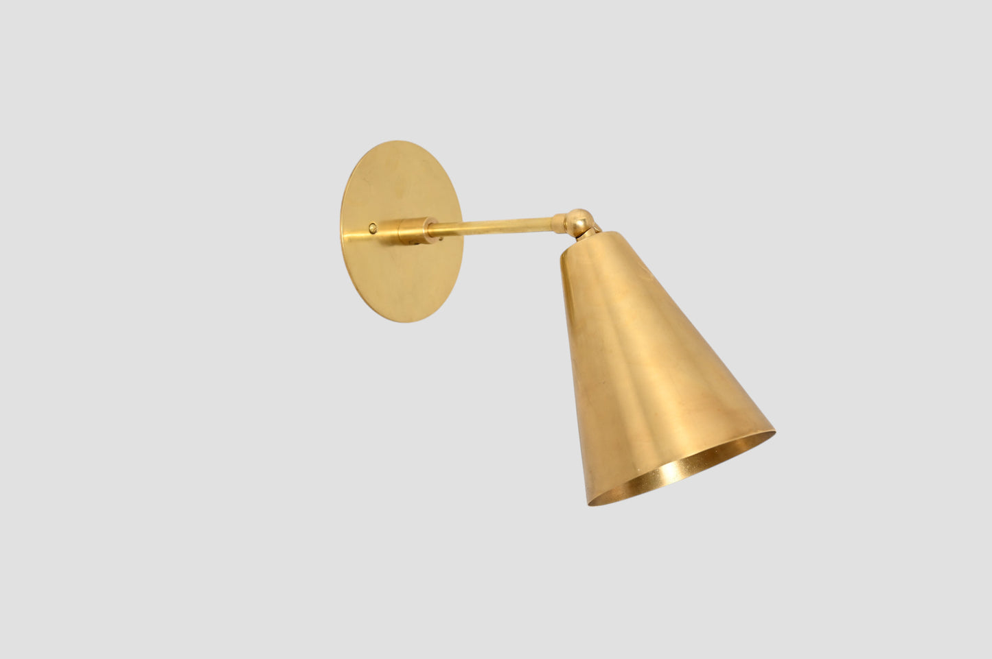 Mid-Century Modern Cone Wall Light: Raw brass, radiant glow, sleek timeless design