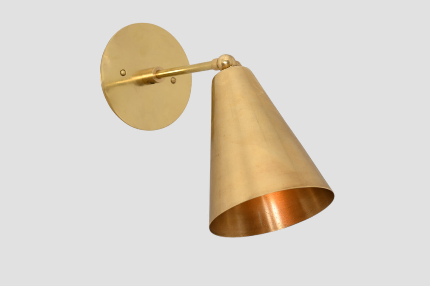 Mid-Century Modern Cone Wall Light: Raw brass, radiant glow, sleek timeless design