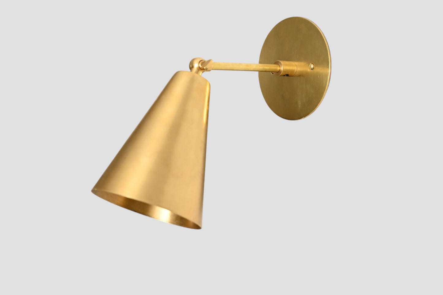 Mid-Century Modern Cone Wall Light: Raw brass, radiant glow, sleek timeless design