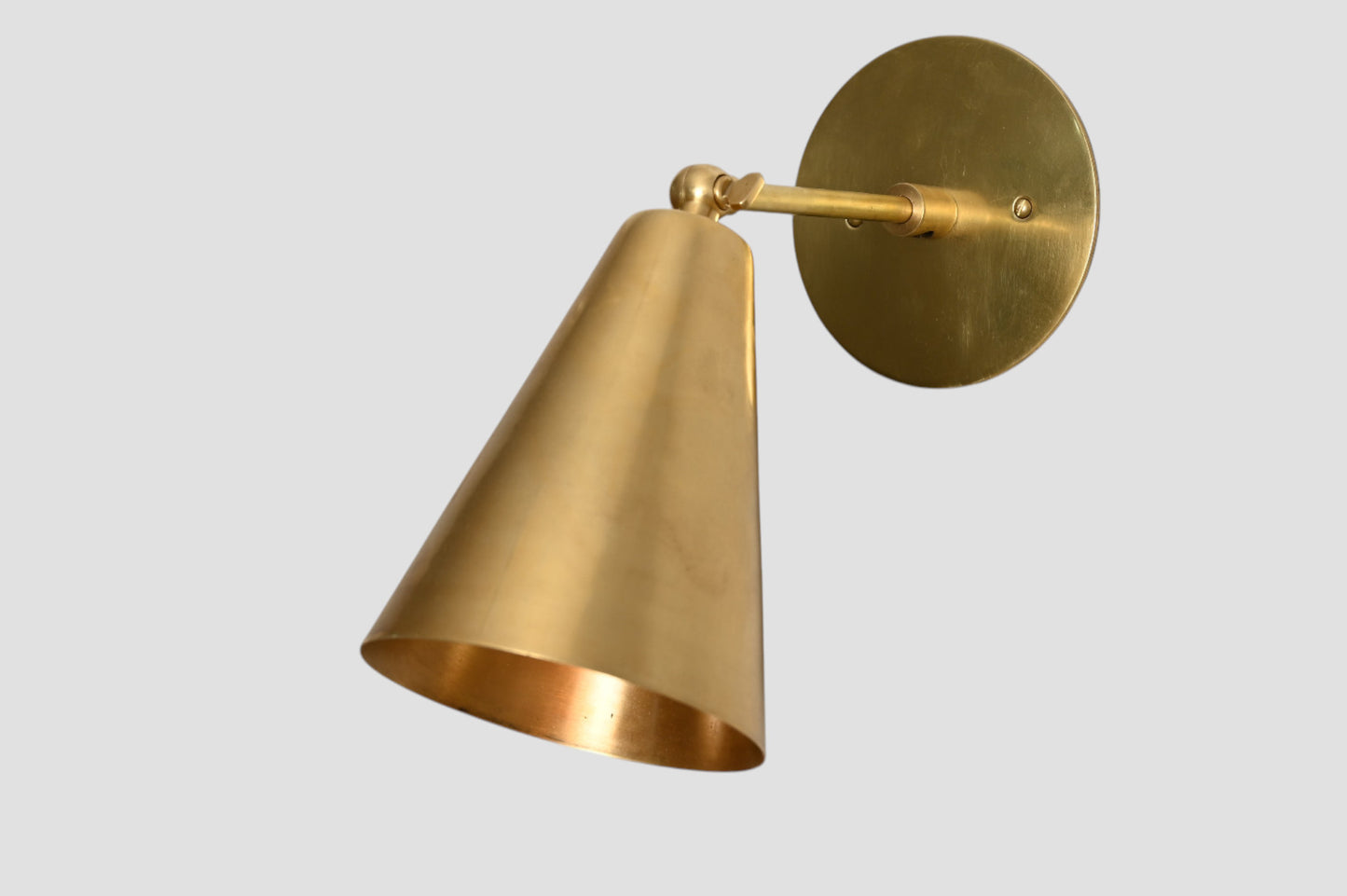 Mid-Century Modern Cone Wall Light: Raw brass, radiant glow, sleek timeless design