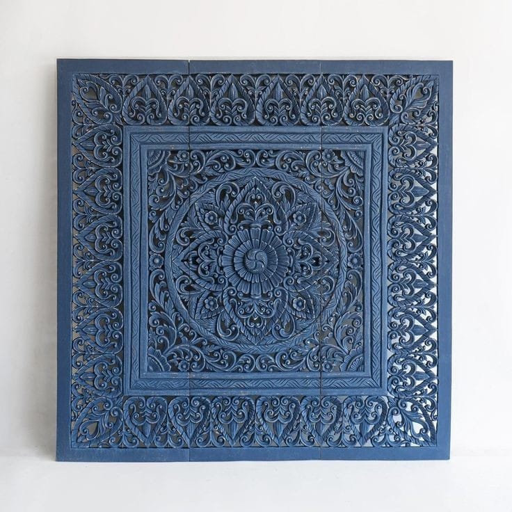 Hand-carved Balinese mandala headboard in a styled bedroom