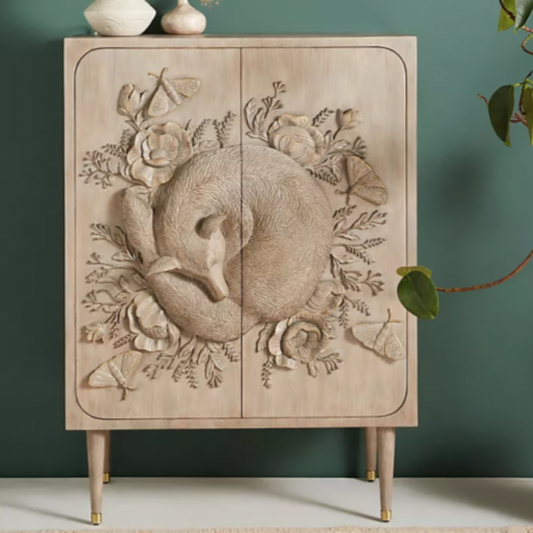 Wooden cabinet featuring intricate floral carvings & a serene fox motif. Its design adds a touch of nature-inspired artistry to any space.