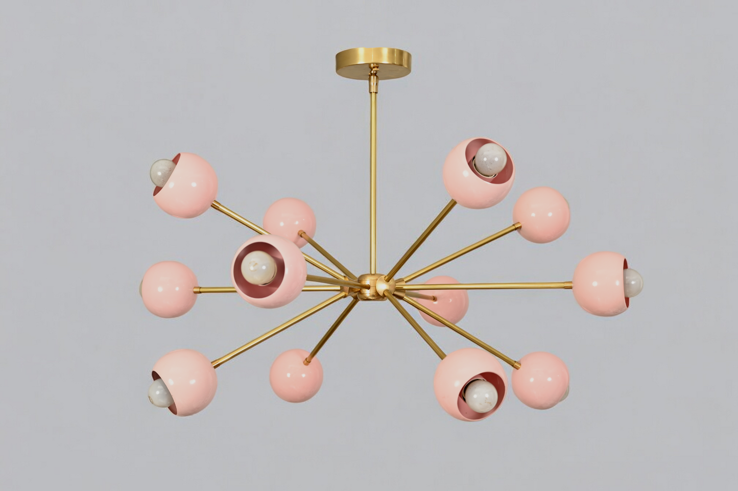 Elegant twelve-arm light pink Sputnik chandelier, a vibrant mid-century starburst fixture.