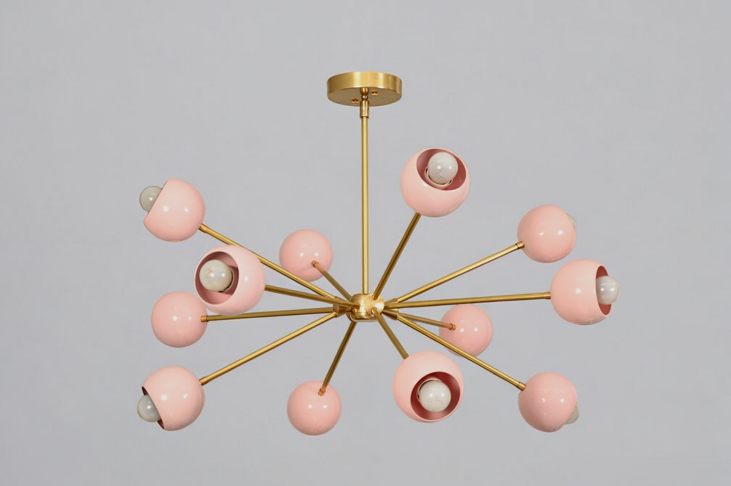 Elegant twelve-arm light pink Sputnik chandelier, a vibrant mid-century starburst fixture.