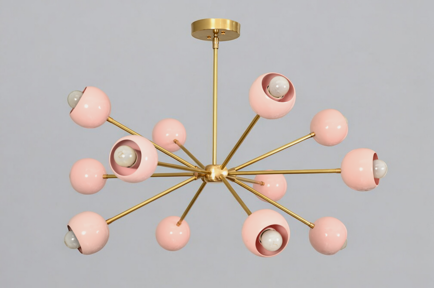 Elegant twelve-arm light pink Sputnik chandelier, a vibrant mid-century starburst fixture.