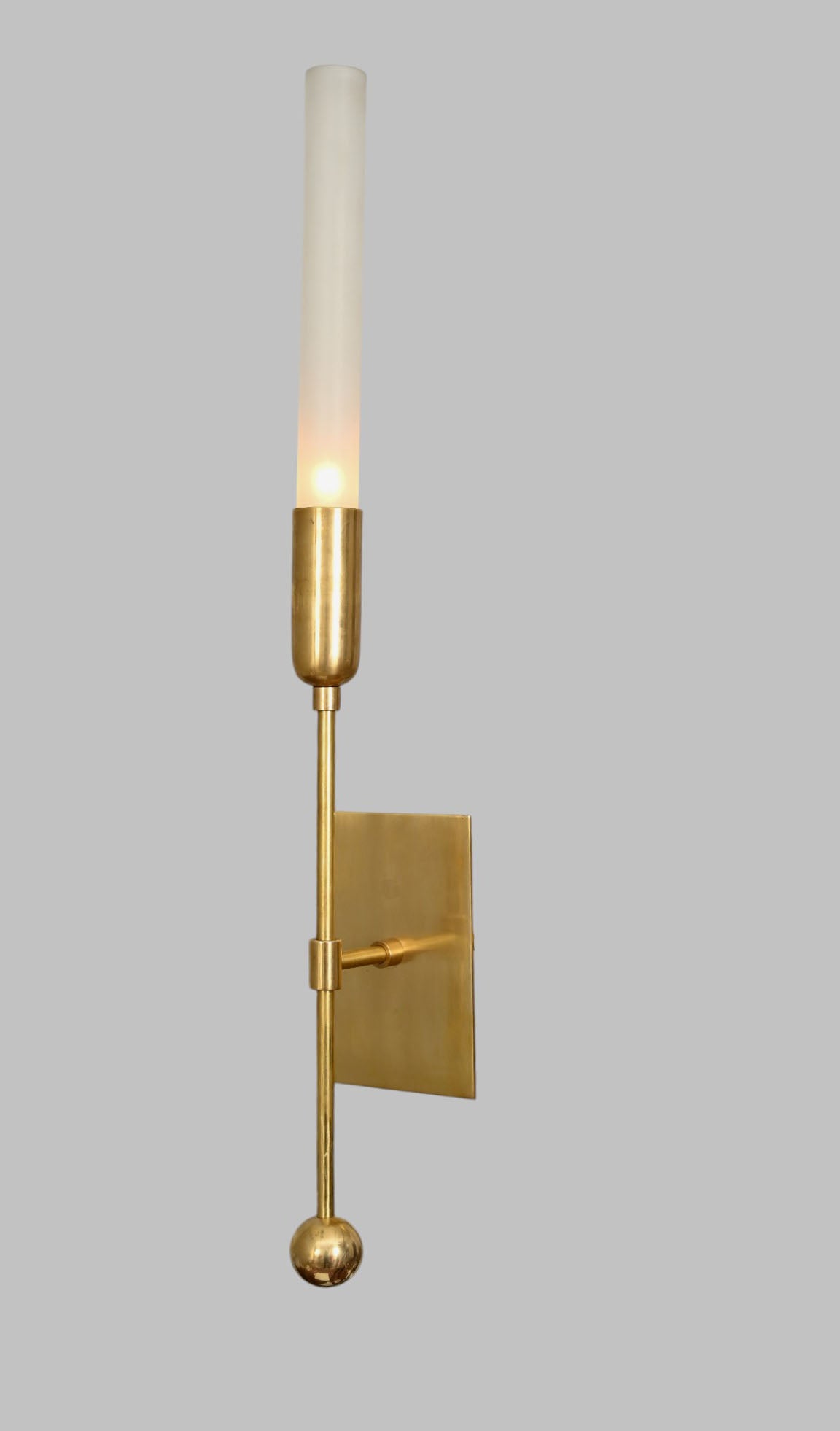 Illuminate your space with the TASSEL 1 Sconce—glass tube with raw brass accents