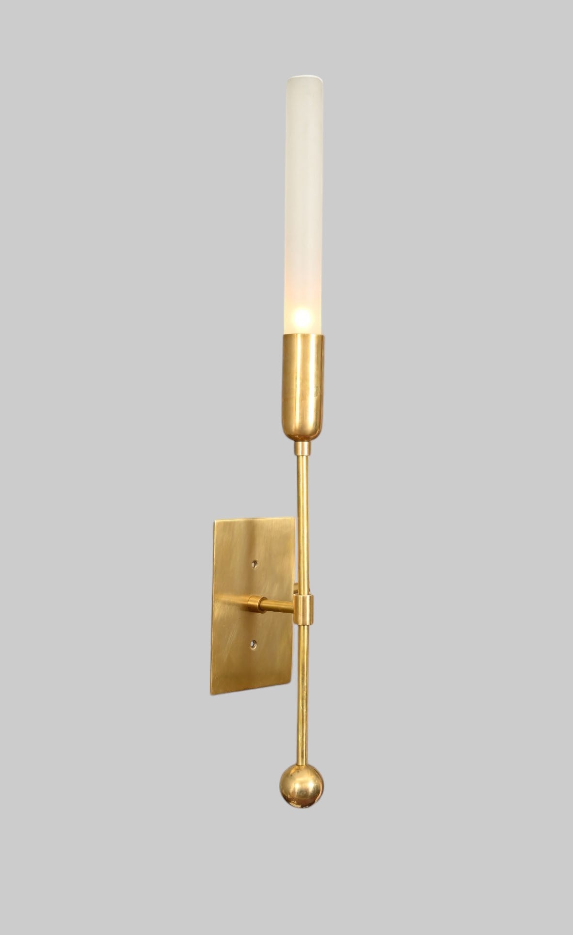 Illuminate your space with the TASSEL 1 Sconce—glass tube with raw brass accents