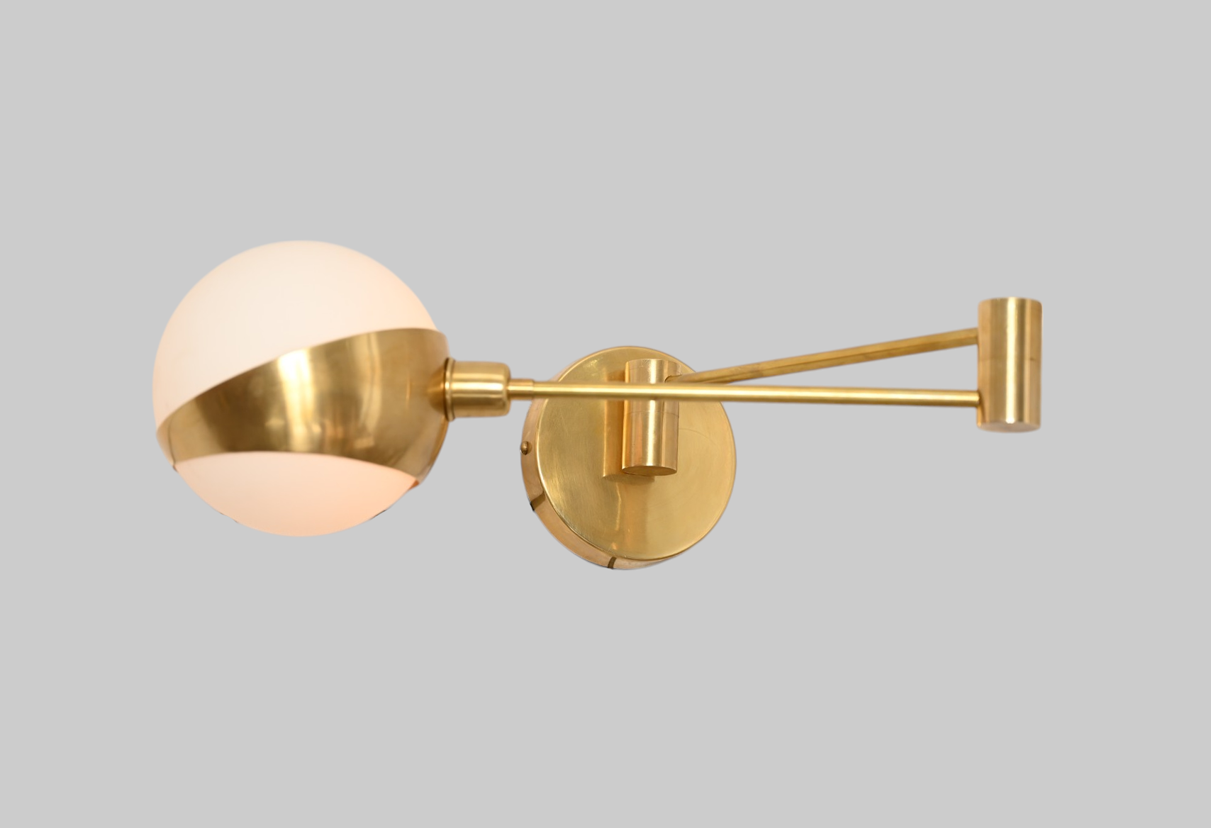 Add elegance with our 1-Light Glass Globe Mid-Century Wall Sconce in Raw Brass