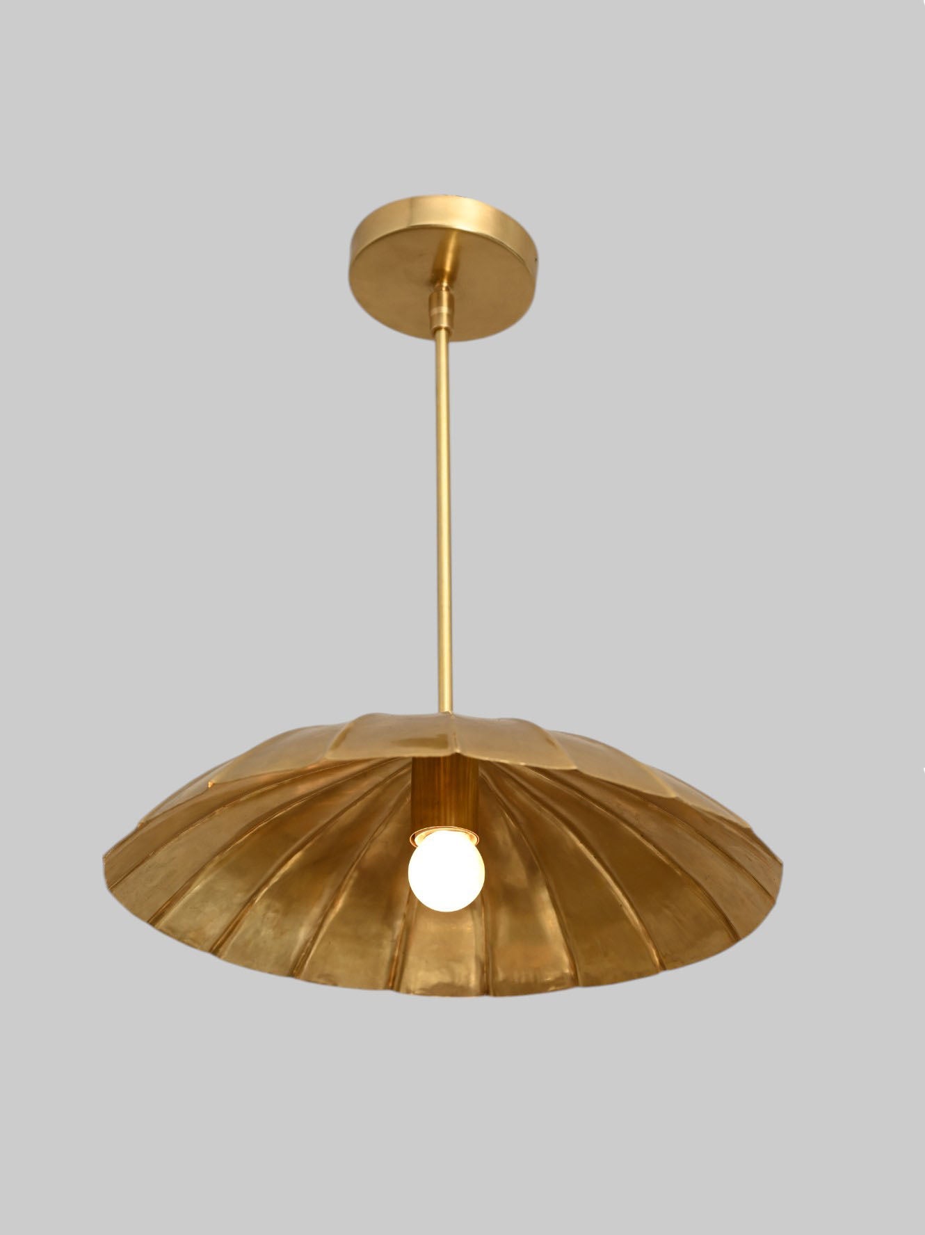 Handcrafted from brass, each chandelier features unique finish variations for a one-of-a-kind look