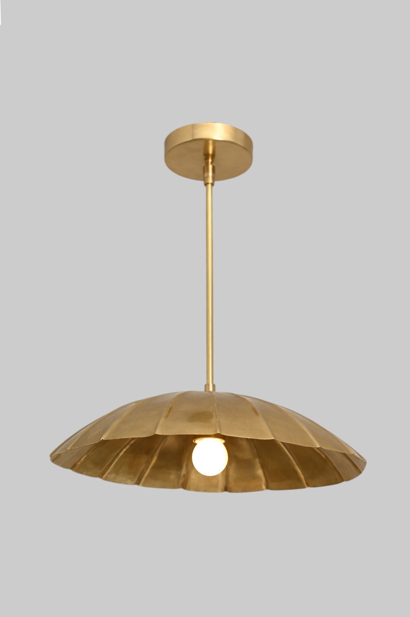 Handcrafted from brass, each chandelier features unique finish variations for a one-of-a-kind look