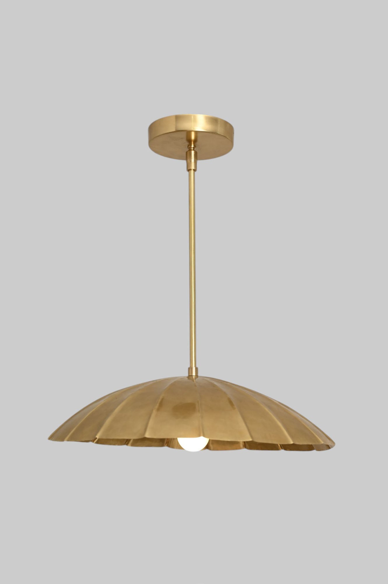 Handcrafted from brass, each chandelier features unique finish variations for a one-of-a-kind look