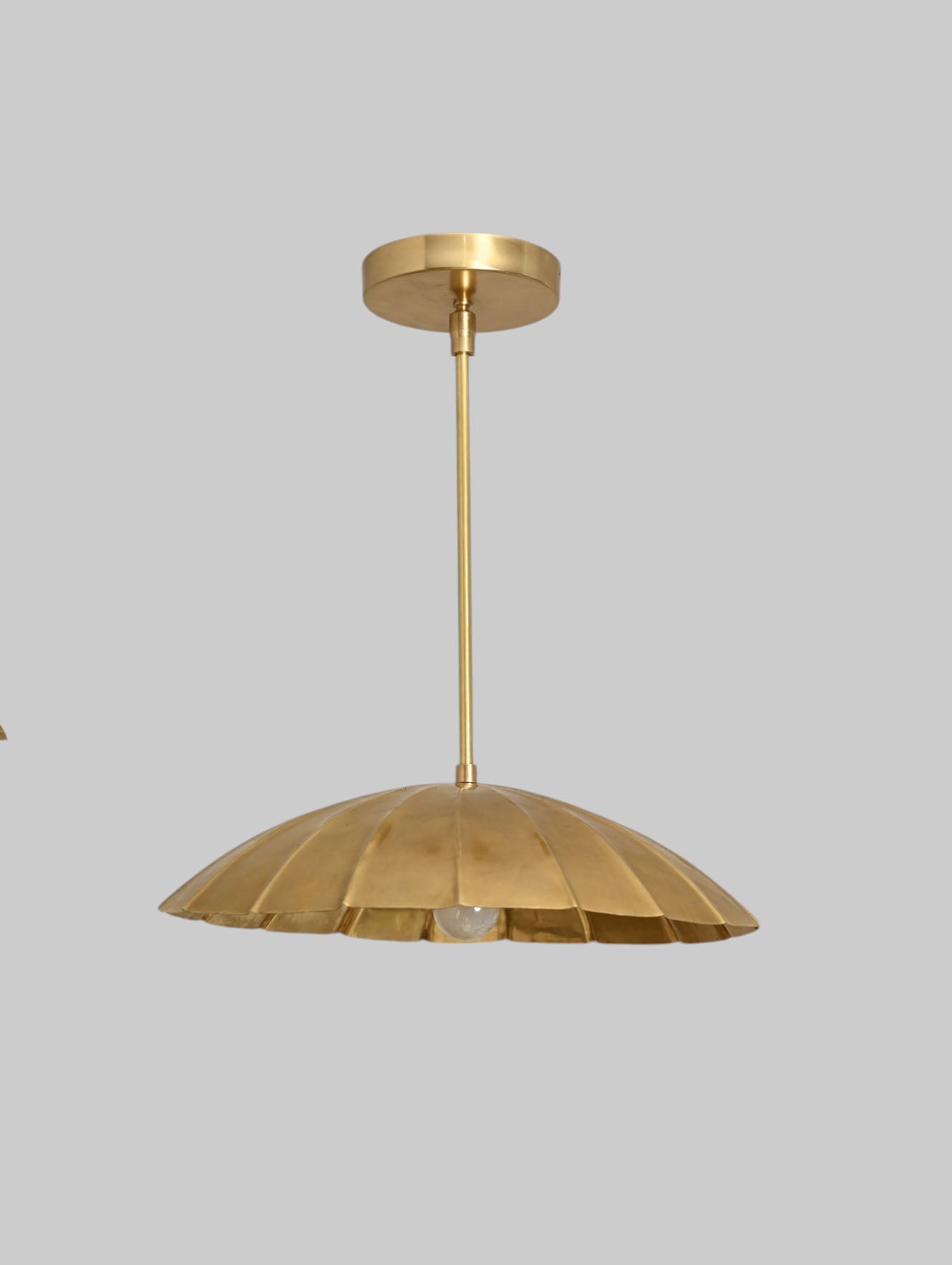 Handcrafted from brass, each chandelier features unique finish variations for a one-of-a-kind look