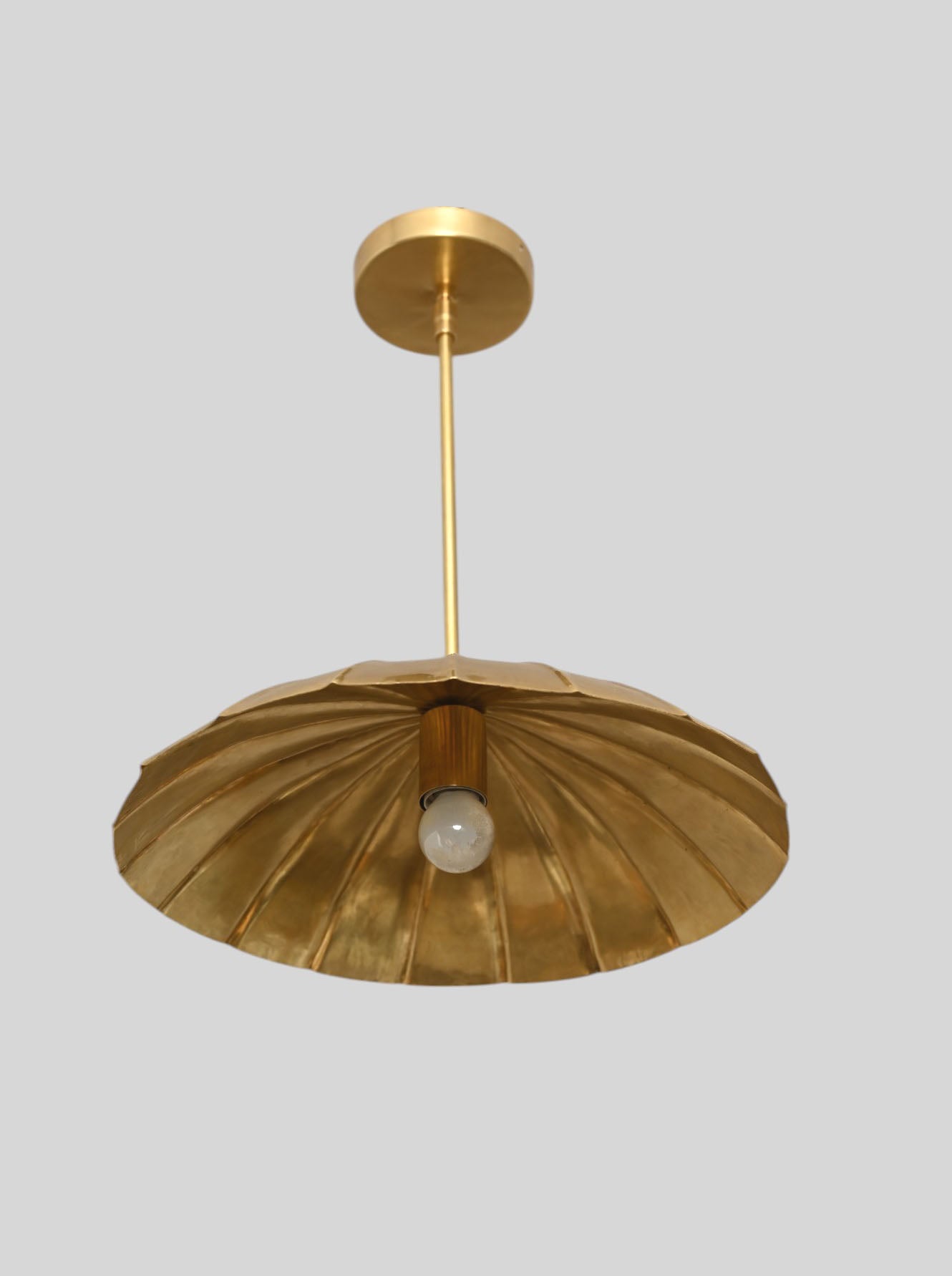 Handcrafted from brass, each chandelier features unique finish variations for a one-of-a-kind look