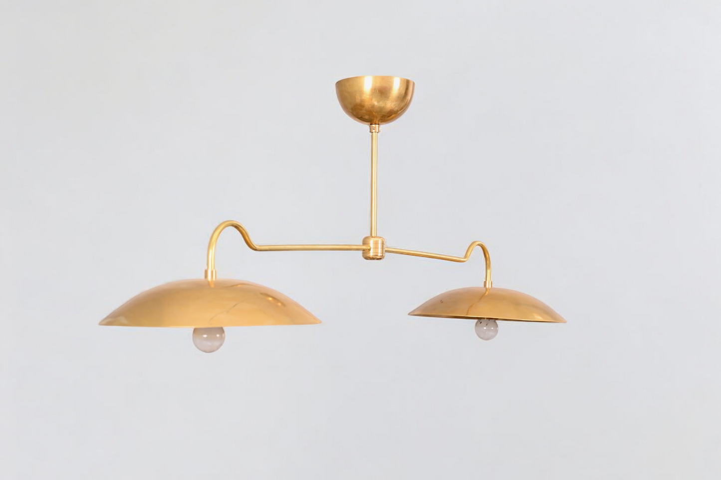 Brighten your space with the Mid Century 2-Light Raw Brass Sputnik Pendant