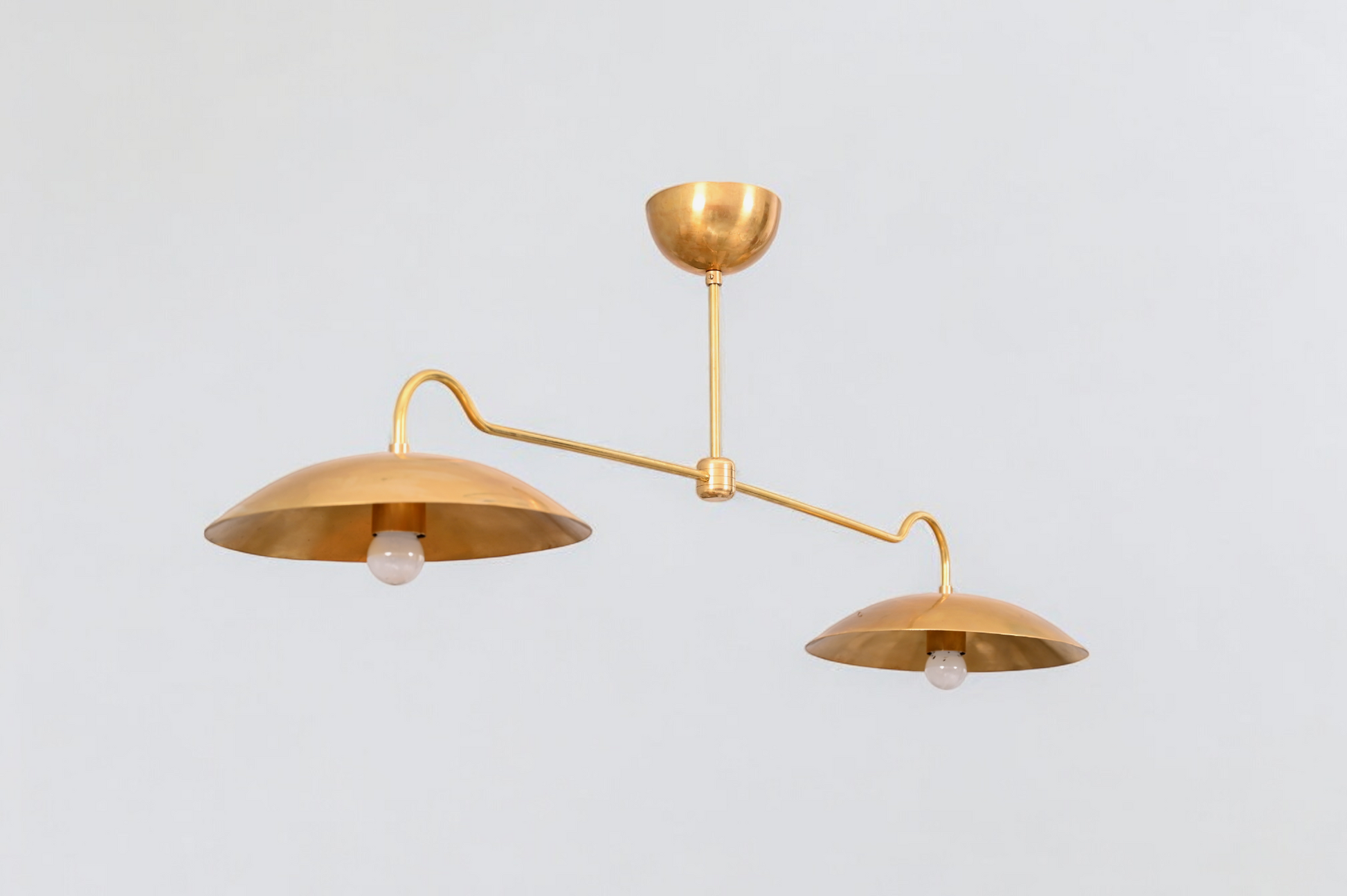 Brighten your space with the Mid Century 2-Light Raw Brass Sputnik Pendant