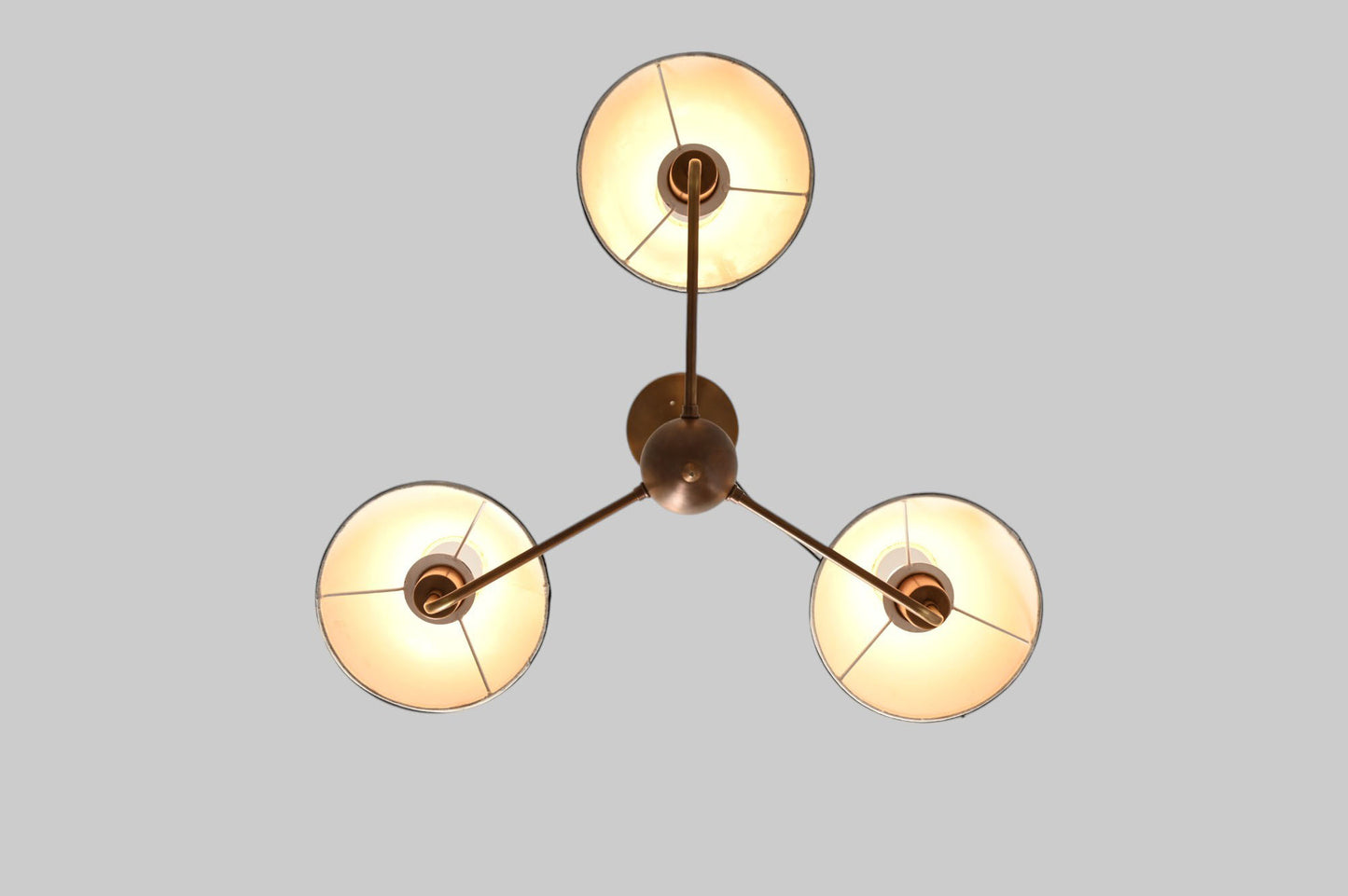 3-shade brass chandelier with unique finish variations for a one-of-a-kind design.