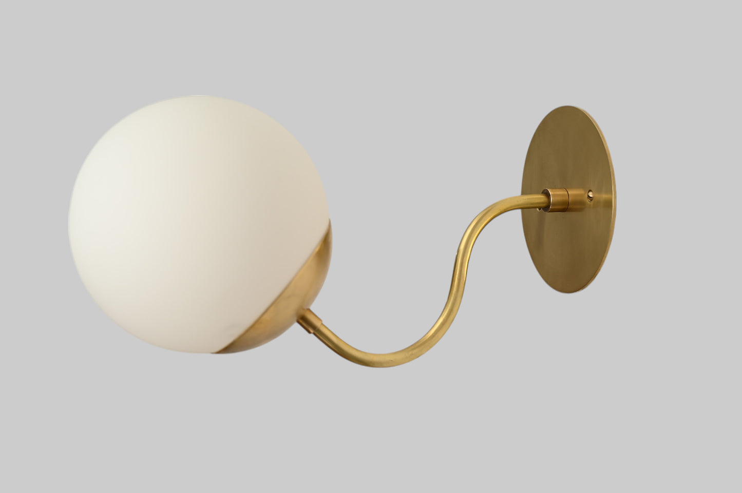 Mid-century modern wall sconces with raw brass finish and Sputnik design, stylish elegance