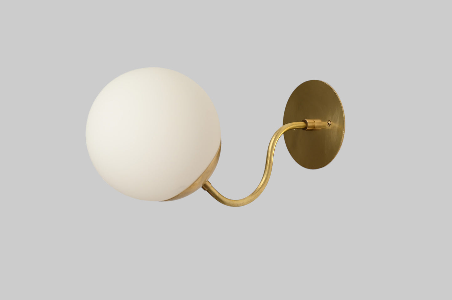 Mid-century modern wall sconces with raw brass finish and Sputnik design, stylish elegance