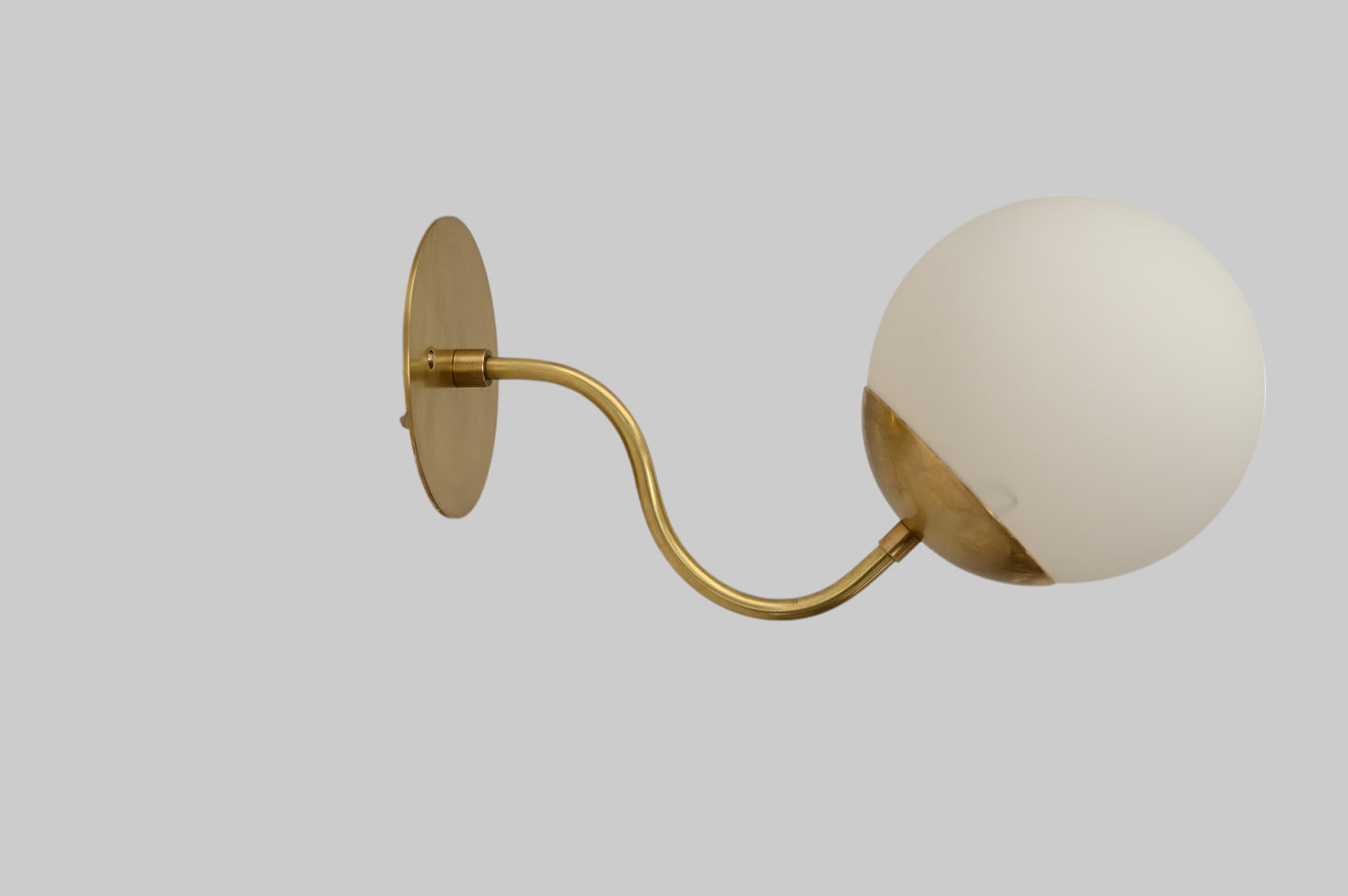 Mid-century modern wall sconces with raw brass finish and Sputnik design, stylish elegance