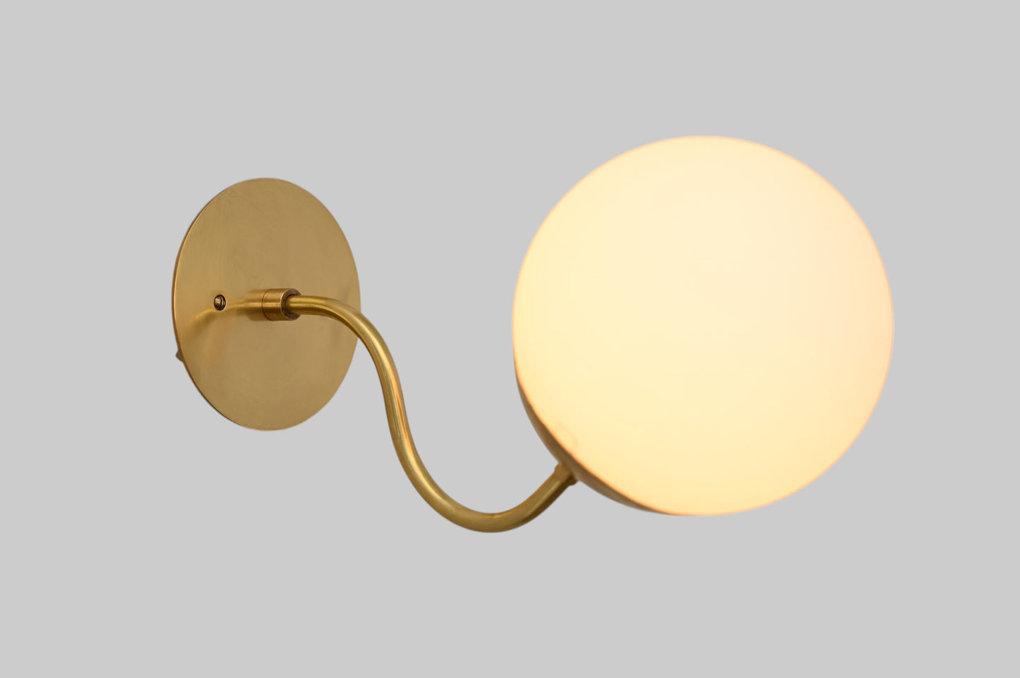 Mid-century modern wall sconces with raw brass finish and Sputnik design, stylish elegance