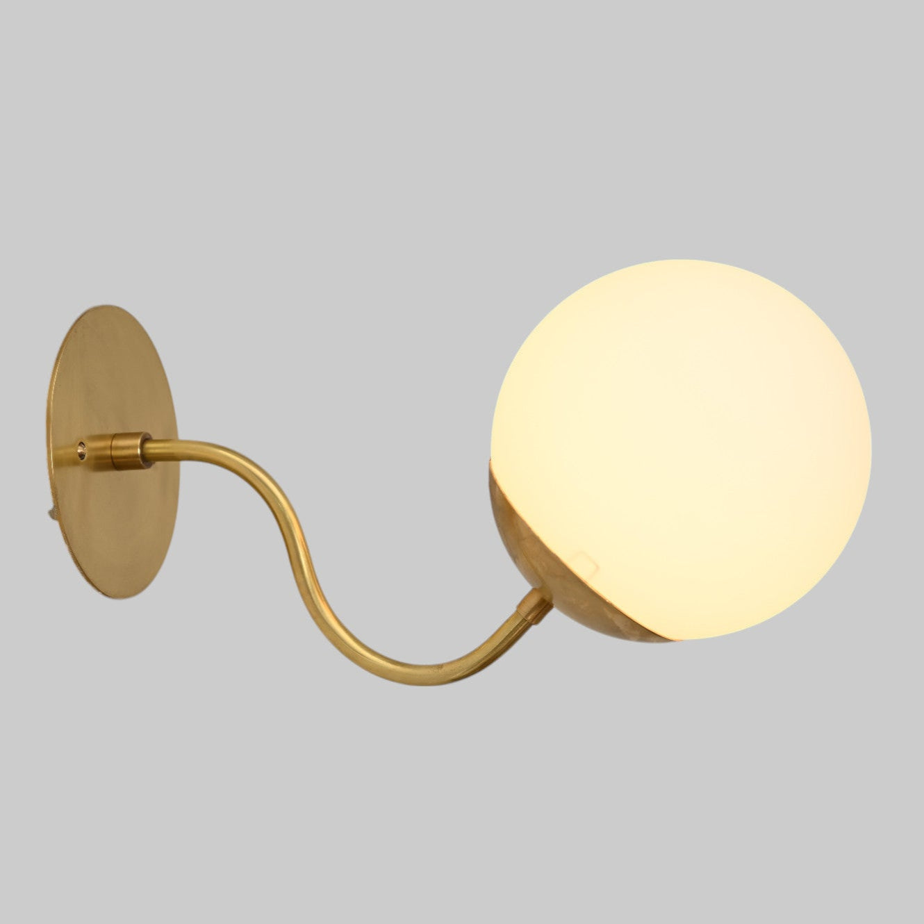 Mid-century modern wall sconces with raw brass finish and Sputnik design, stylish elegance