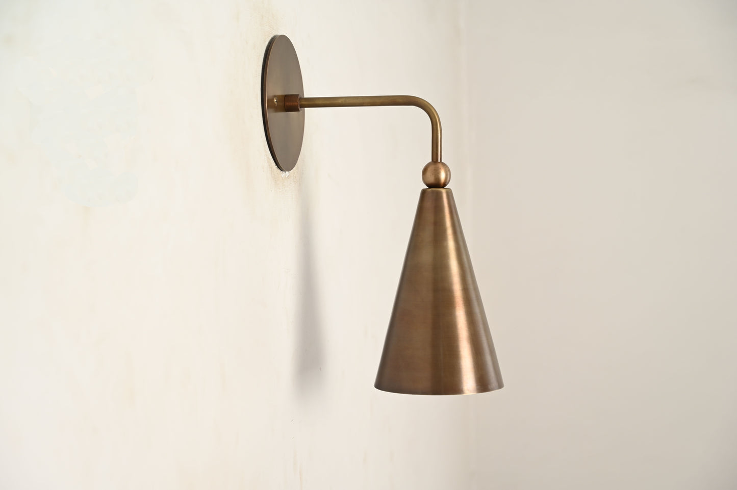 Mid-century modern wall sconces with raw brass finish and Sputnik design, stylish elegance