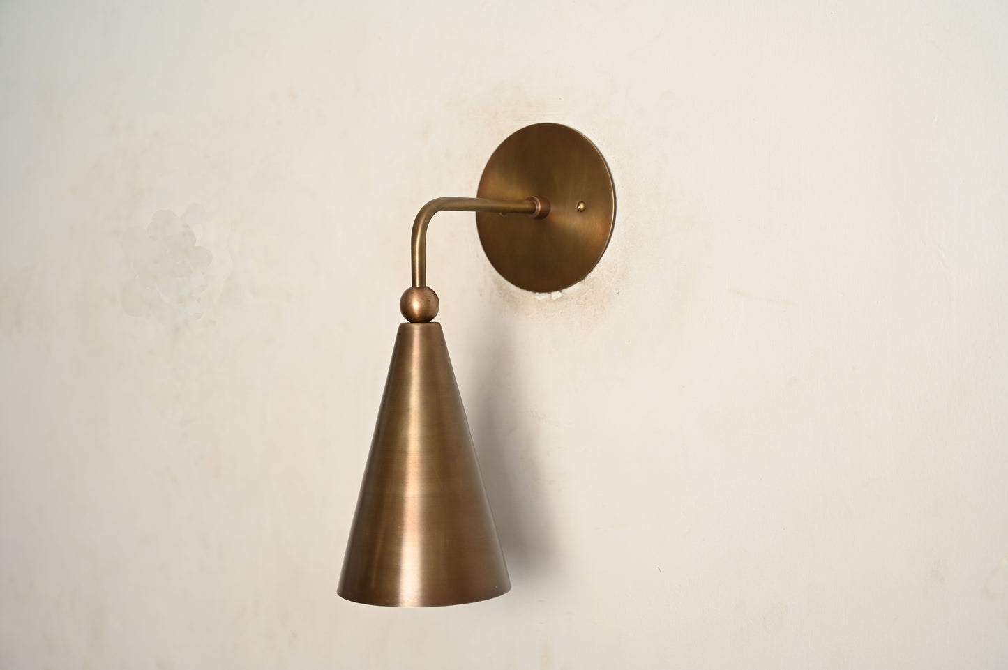 Mid-century modern wall sconces with raw brass finish and Sputnik design, stylish elegance