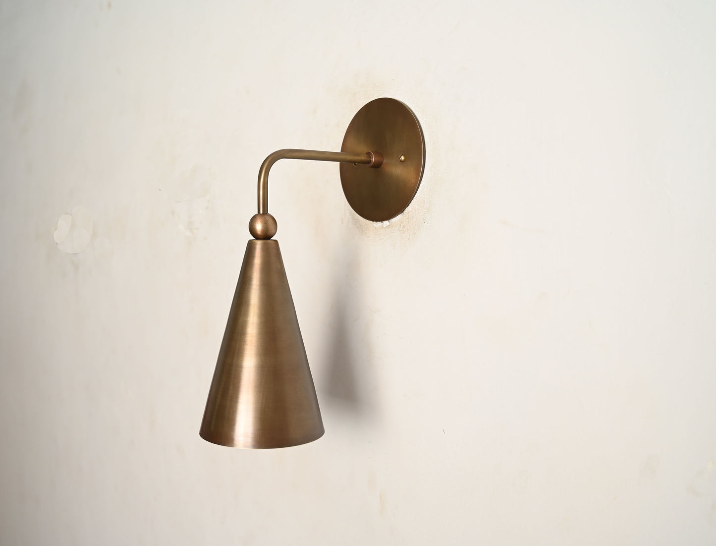 Mid-century modern wall sconces with raw brass finish and Sputnik design, stylish elegance