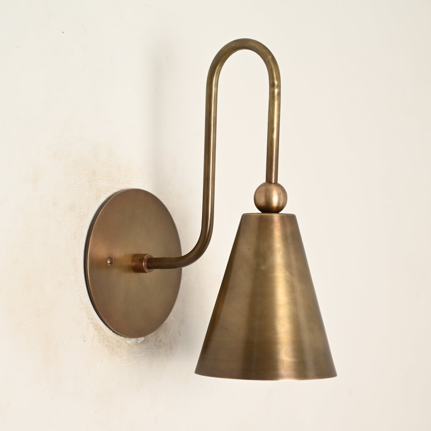 Mid-century modern wall sconces with raw brass finish and Sputnik design, adding style