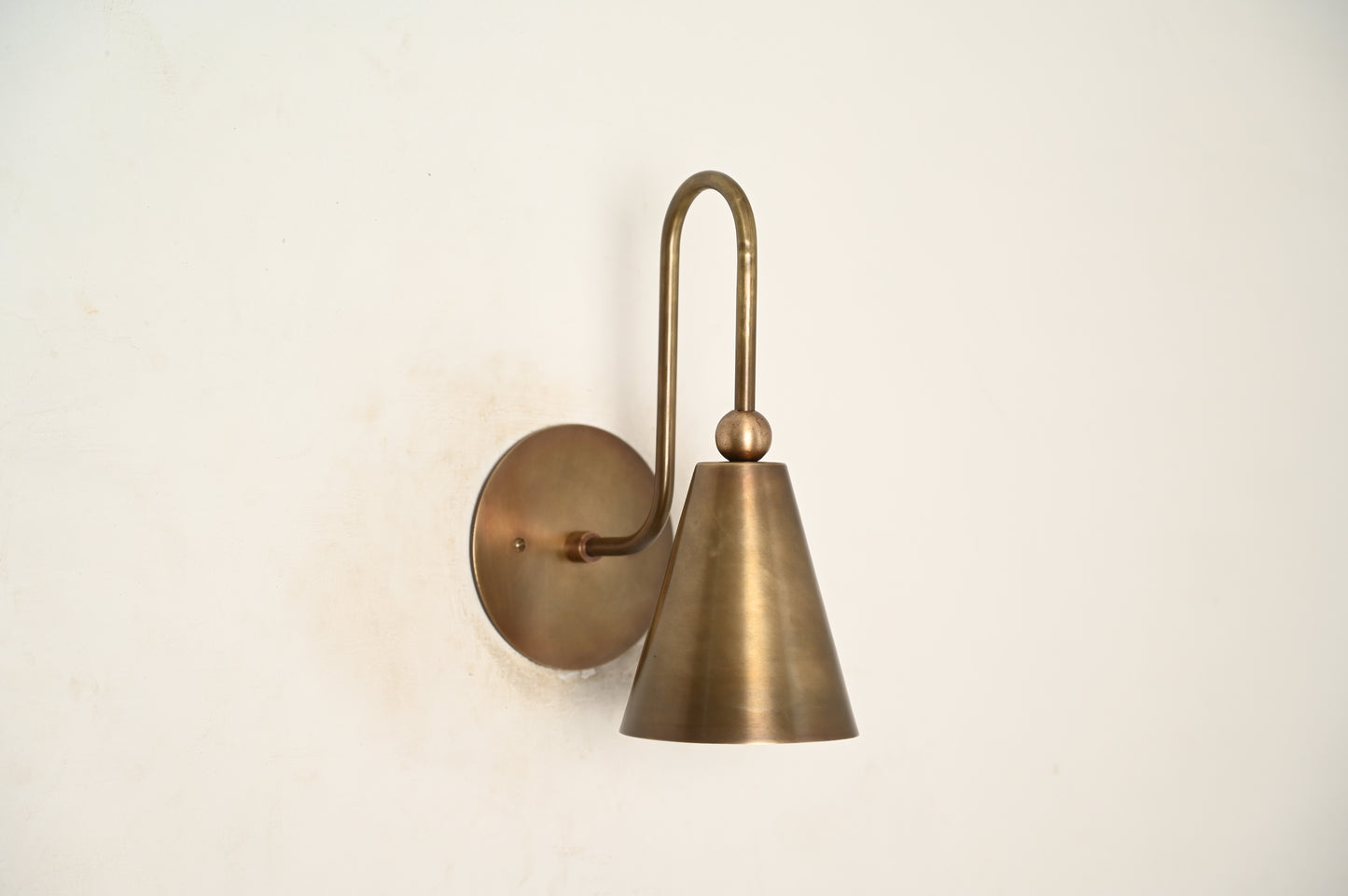 Mid-century modern wall sconces with raw brass finish and Sputnik design, adding style