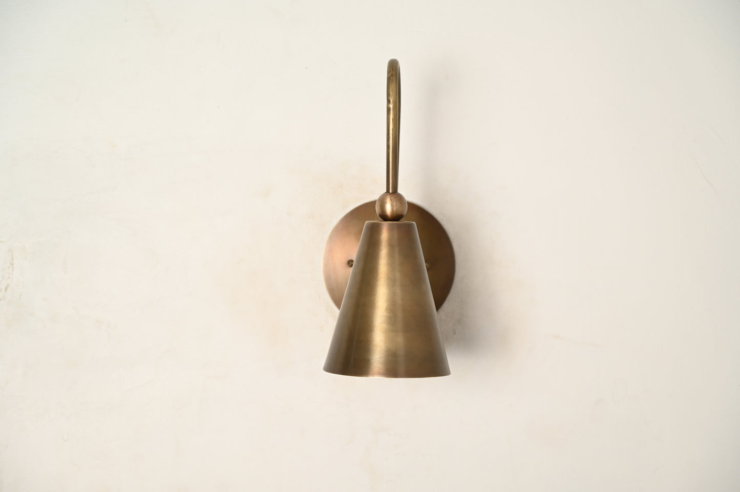 Mid-century modern wall sconces with raw brass finish and Sputnik design, adding style