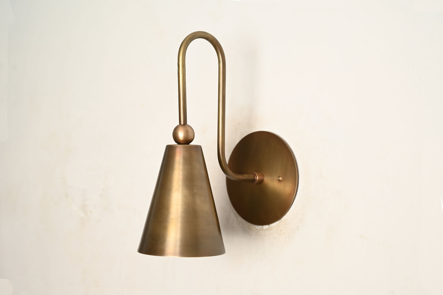 Mid-century modern wall sconces with raw brass finish and Sputnik design, adding style