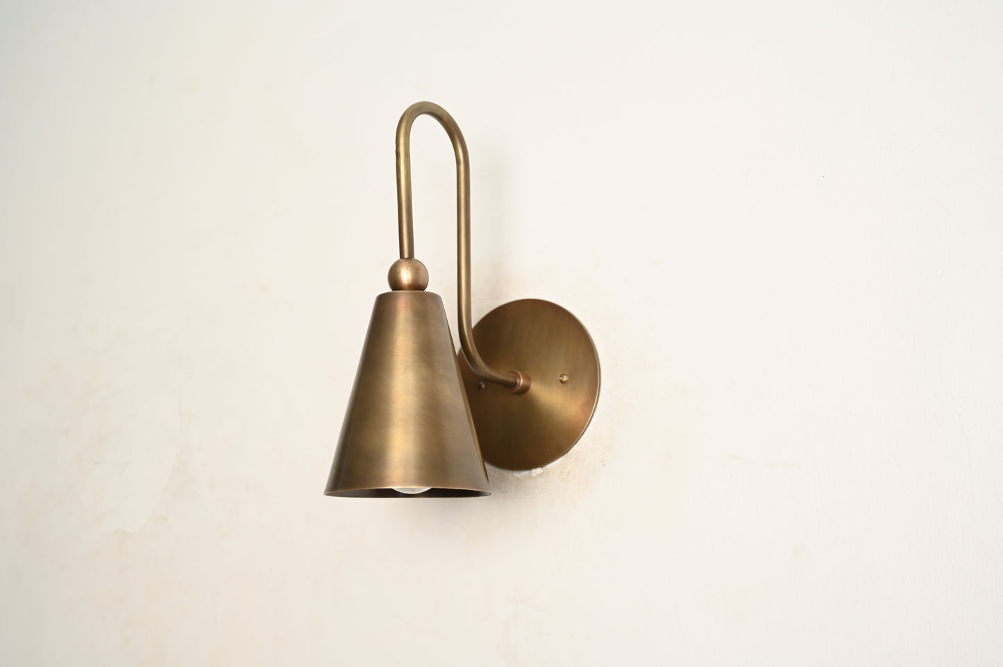 Mid-century modern wall sconces with raw brass finish and Sputnik design, adding style