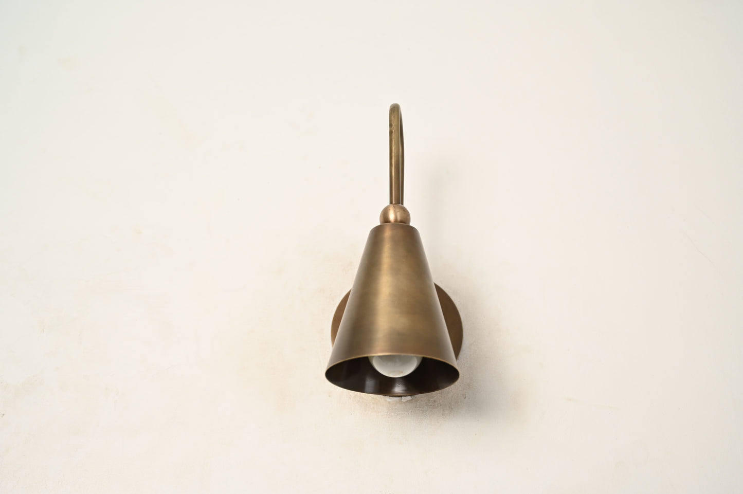 Mid-century modern wall sconces with raw brass finish and Sputnik design, adding style