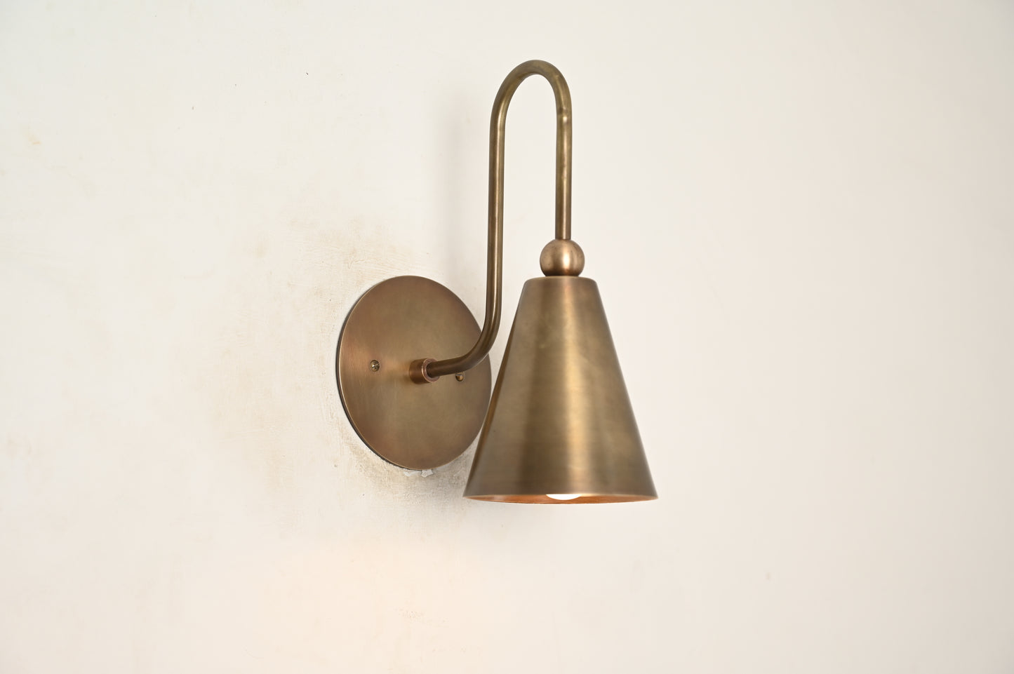 Mid-century modern wall sconces with raw brass finish and Sputnik design, adding style